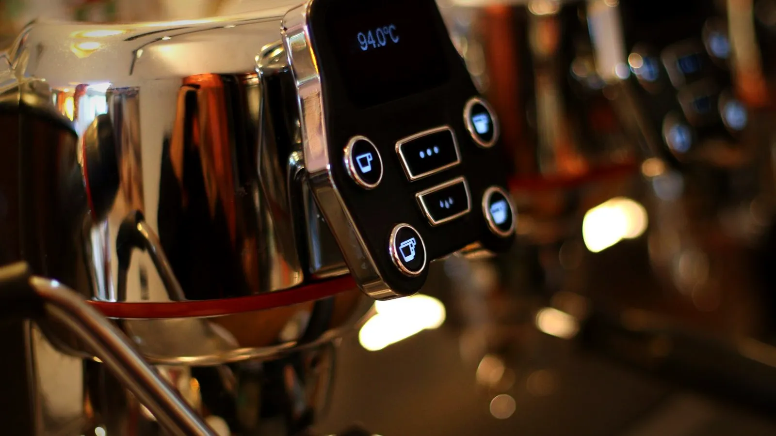 Digital display on an espresso machine group head showing a brew temperature of 94.0 °C